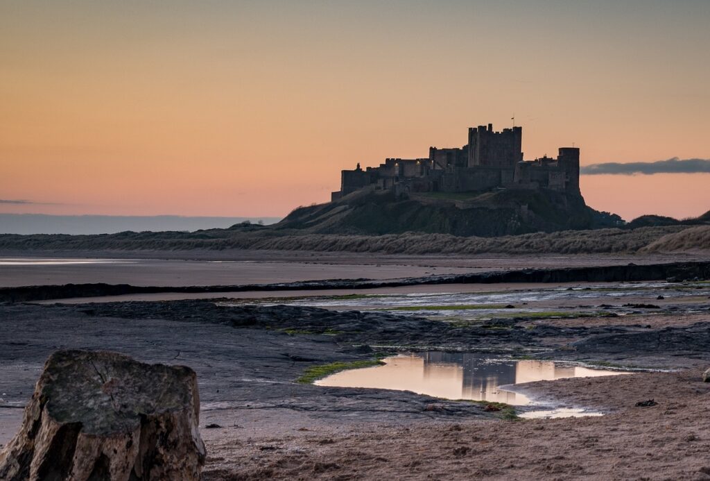 A view of Bamburgh Castle taken from Bamburgh Beach - photo taken by Ebor and sourced via Pixabay.